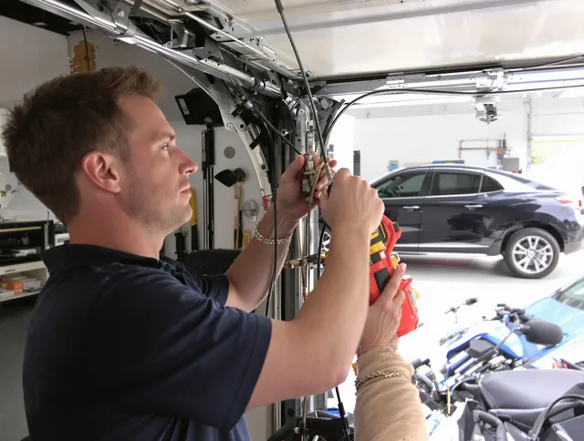 Norwalk Garage Door Repair safety certified technician performing cable replacement in Norwalk